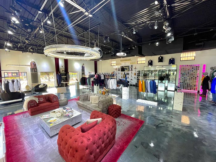 Men&rsquo;s tailored suits showroom in Dallas featuring custom suits, luxury seating, and modern interior at Donmoprhy suit shop