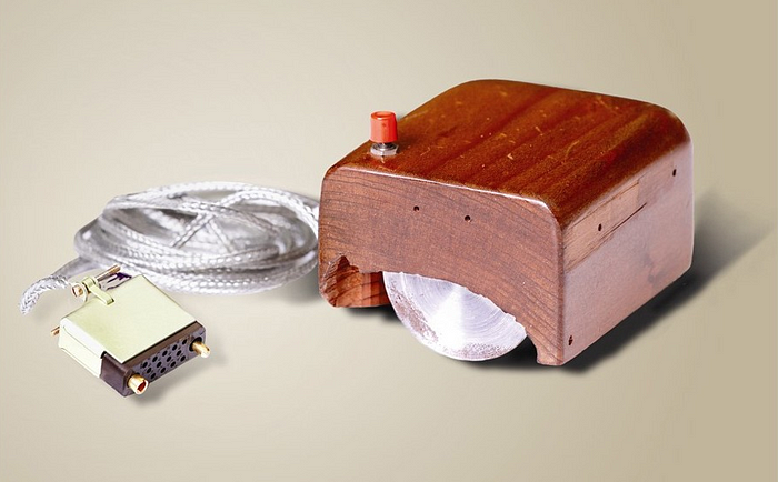 The very first “mouse” — a brown shell made of wood with a single red button on top.