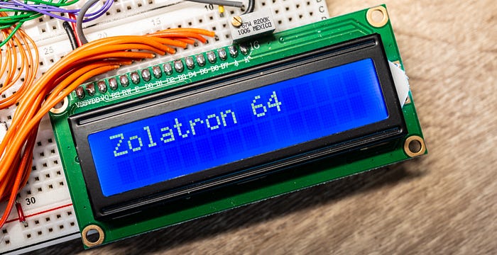 Close-up photograph of an LCD panel displaying: ‘Zolatron 64’.