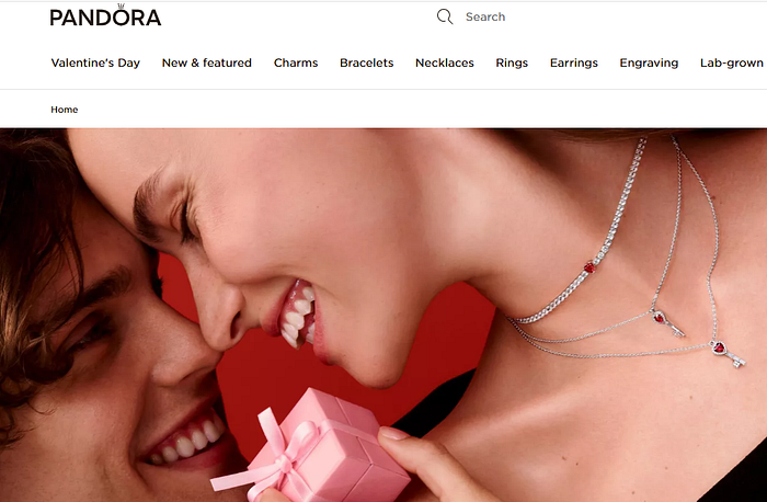 Pandora Valentine’s Day campaign showcasing a couple sharing an intimate moment with heart-inspired jewelry, highlighting branded romance and emotional storytelling.