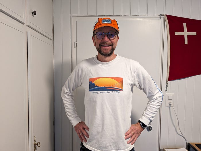 The author wearing a New York City Marathon shirt and hat