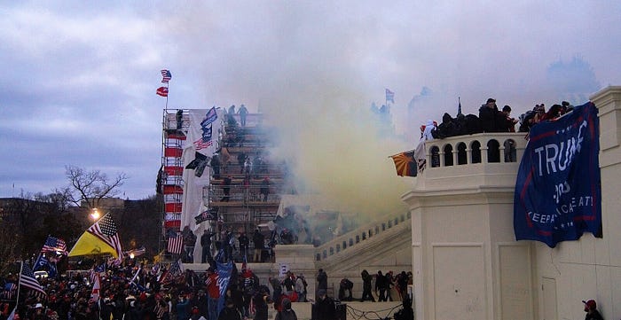 A photo of the rioters / insurgents attacking the U.S. Capitol on January 6, 2021, many waving “Trump” flags.