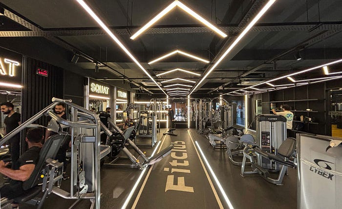 Modern Fitclub franchise gym with advanced equipment and sleek interior