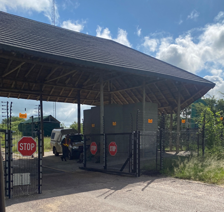 Entry check at Orpen Gate; stop signs; security fencing