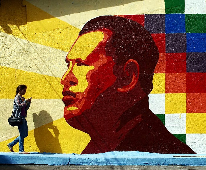 Street art painting of Hugo Chavez, facing to the side, brightly colored.