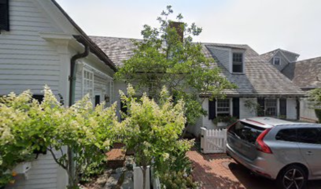 A small white Cape Cod style house that was the former home of author John Dos Passos in Provincetown, Massachusetts.