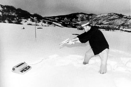 Hunter S Thompson shooting a typewriter
