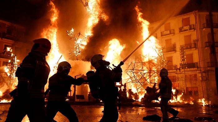 Firemen putting out the flames during the celebration