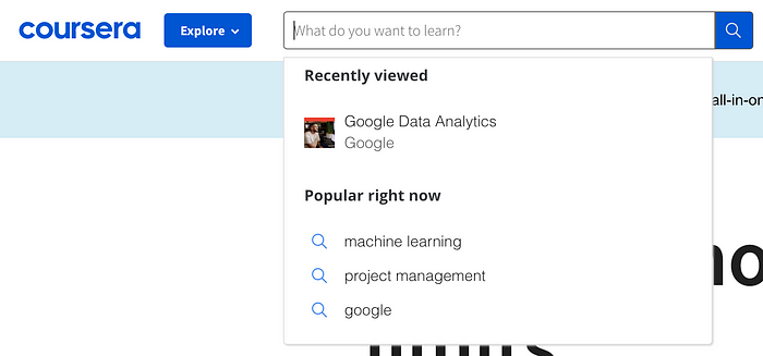 A screenshot of Coursera’s search bar open that has placeholder text reading “What do you want to learn?”. In a dropdown below, there is a section for “Recently viewed” and “Popular right now”.