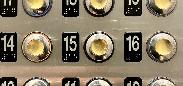 The interior buttons of an elevator with floor 14 selected
