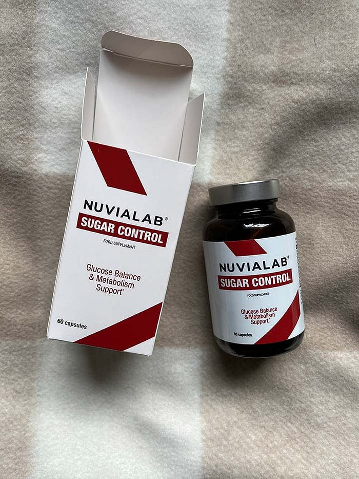 A close-up of the NuviaLab Sugar Control supplement bottle, featuring natural ingredients like berberine and cinnamon to help regulate blood sugar levels and support overall health