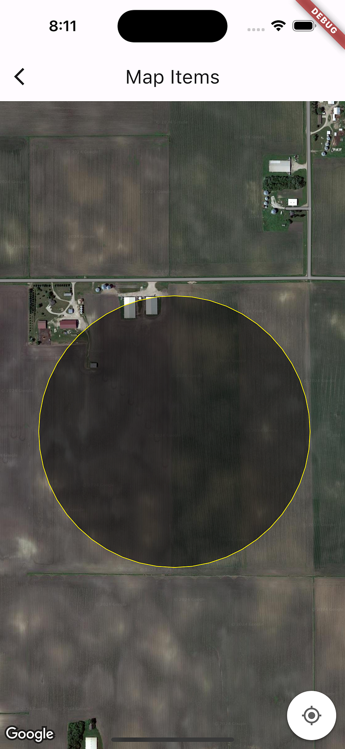 A screenshot of a map open on a smartphone. The map is showing satellite image of a farm in Northern part of USA. A circle is drawn on the map, the colour of the circle is yellow and it is filled with translucent black color.