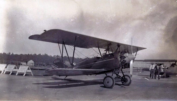 A black and white photo of a Travel Air 4000 bi-plane from 1925.