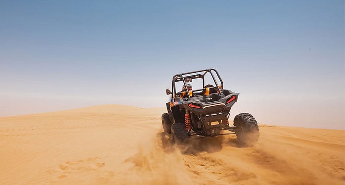 Desertxtremeadventures Off-road buggy on golden dunes during desert safari Dubai.