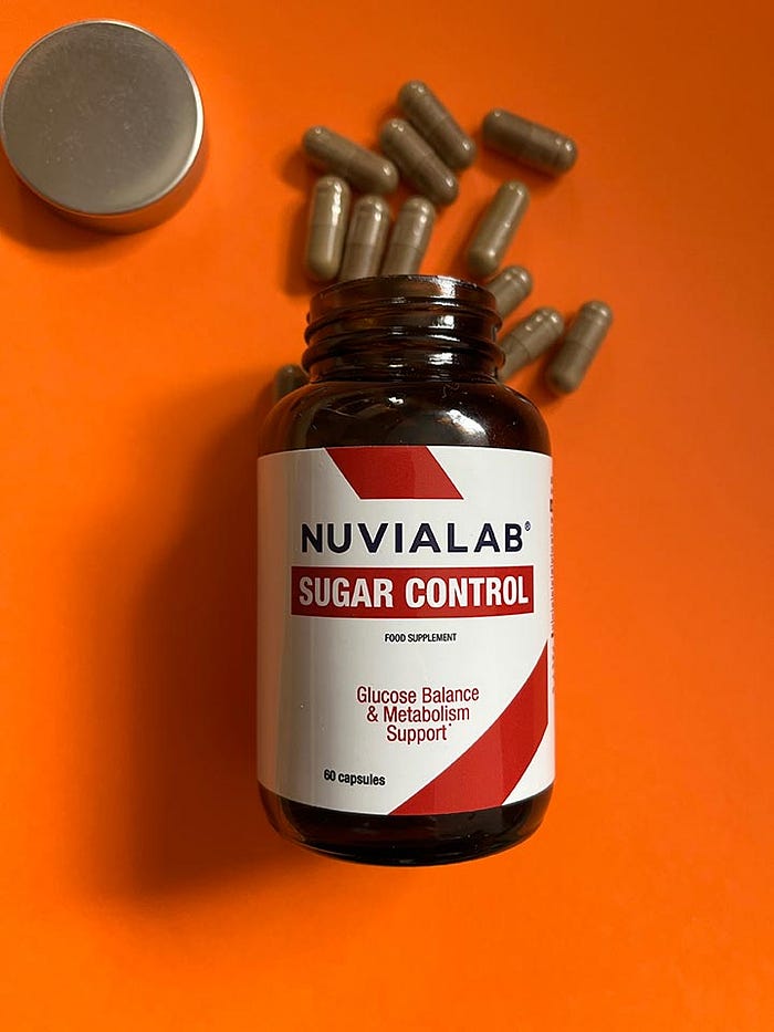A bottle of NuviaLab Sugar Control dietary supplement with a white label and green accents, containing natural ingredients to support healthy blood sugar levels.