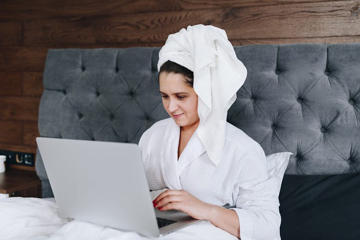 A woman working from home in her bathrobe 