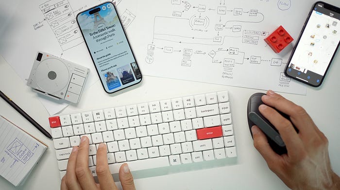 Design studio tabletop with sketches, apps and drawings