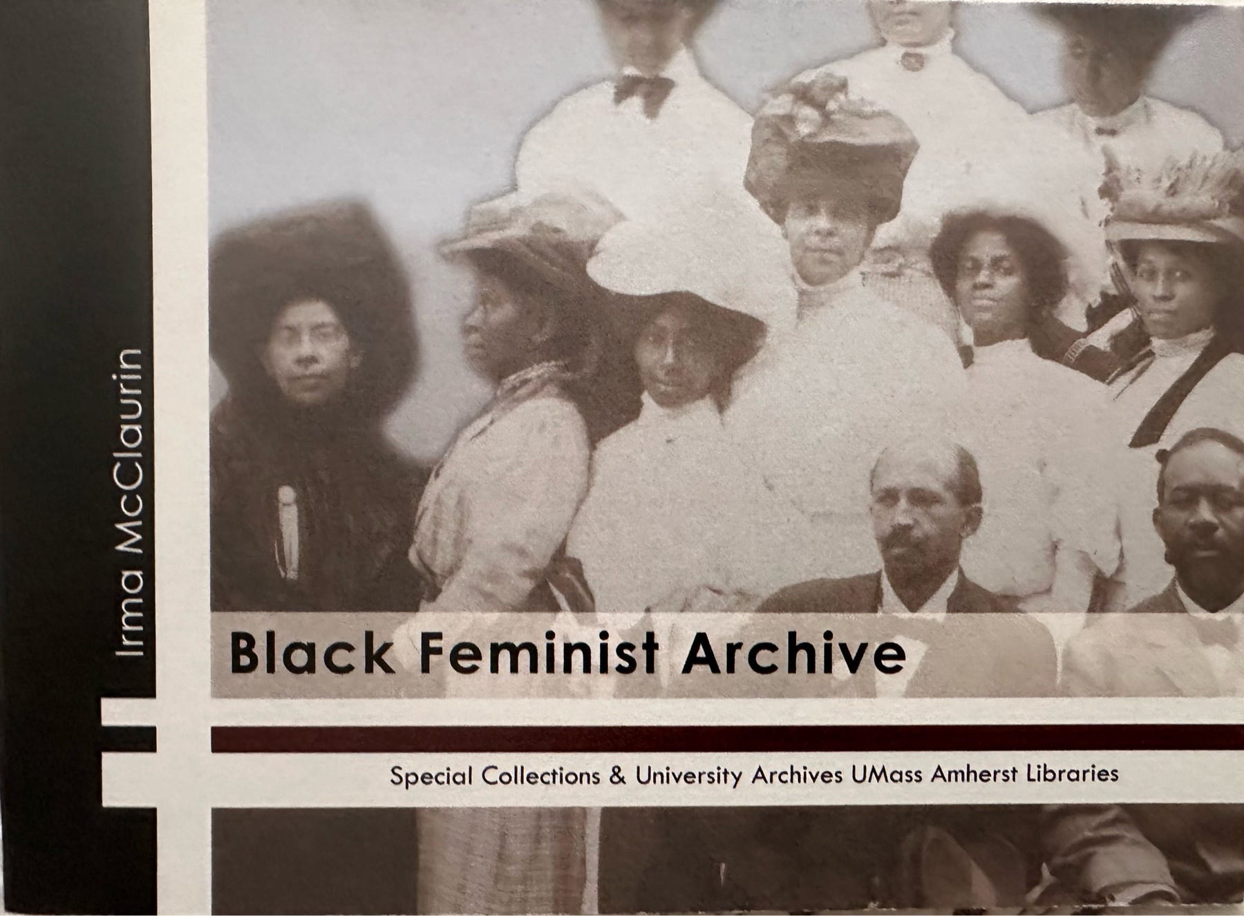 A photograph is taken of a group of people, including Irma McClaurin, in the Black Feminist Archive. 