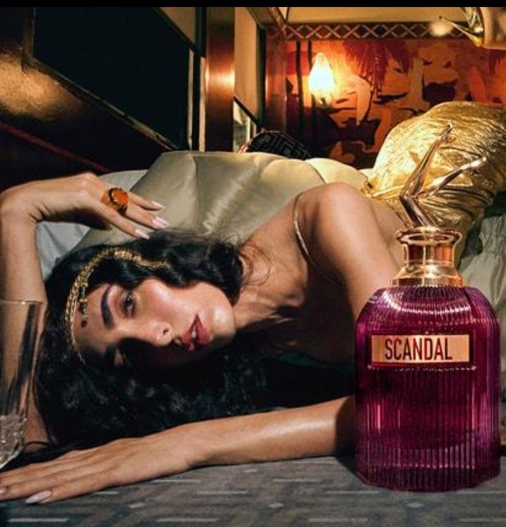 The perfume is called “Scandal,” but the real scandal is how effortlessly advertising still turns women into atmosphere. Image source: Scandal perfume advertising campaign
