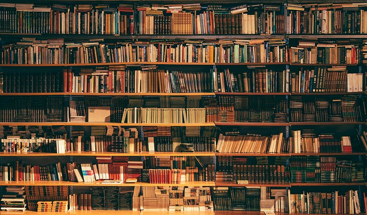 The vast, ornate reading room of a public library, filled with books and quiet corners.