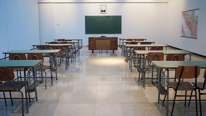 An old, black-and-white photograph of a university lecture hall, evoking a sense of psychological study and history.