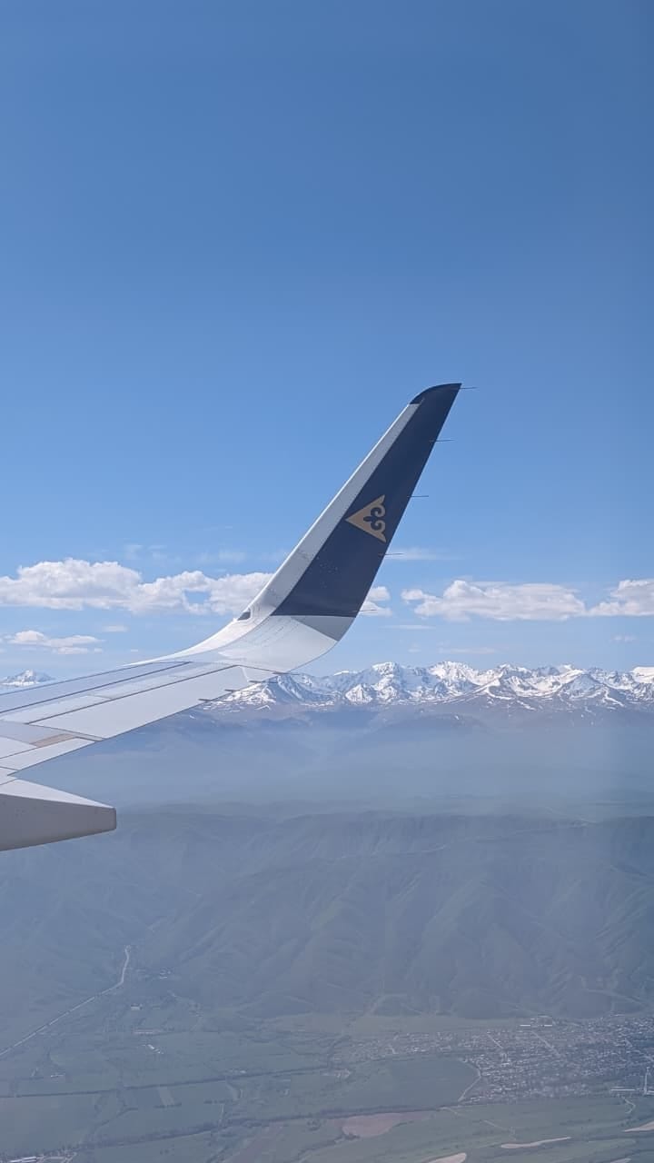 My first glimpse of Almaty — where a bustling city meets the snow-capped Tian Shan Mountains.
