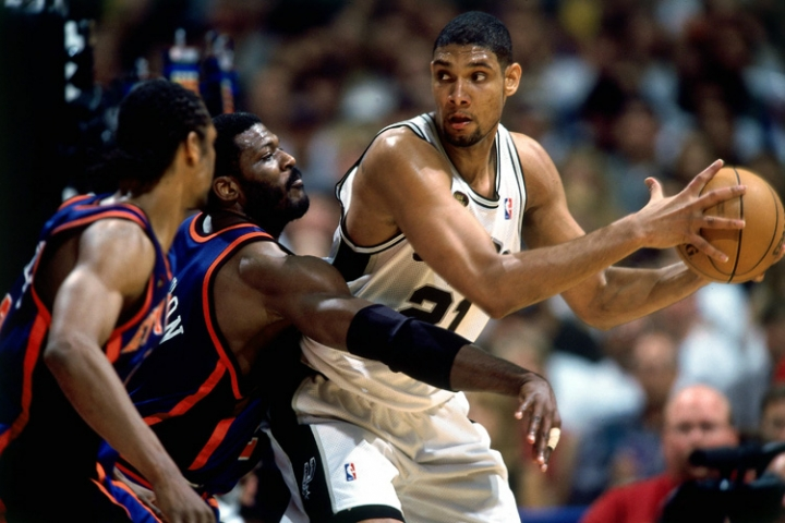 Allan Houston of the New York Knicks shoots against Tim Duncan of