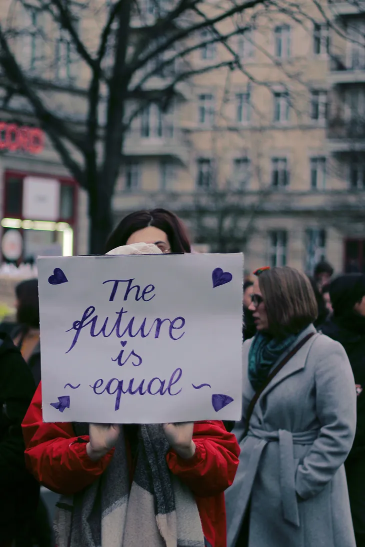 Woman holds sign on strike line