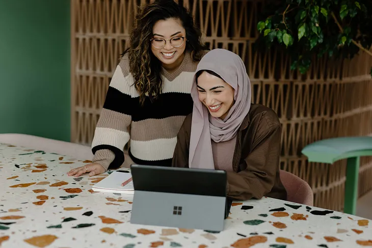 Two women looking at Mircosoft Sylist Tablet