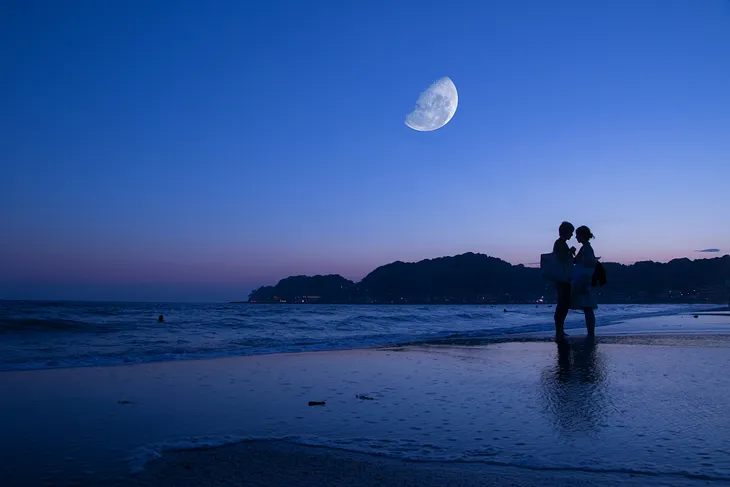 A couple under a violet sky on a Valentine’s Day getaway