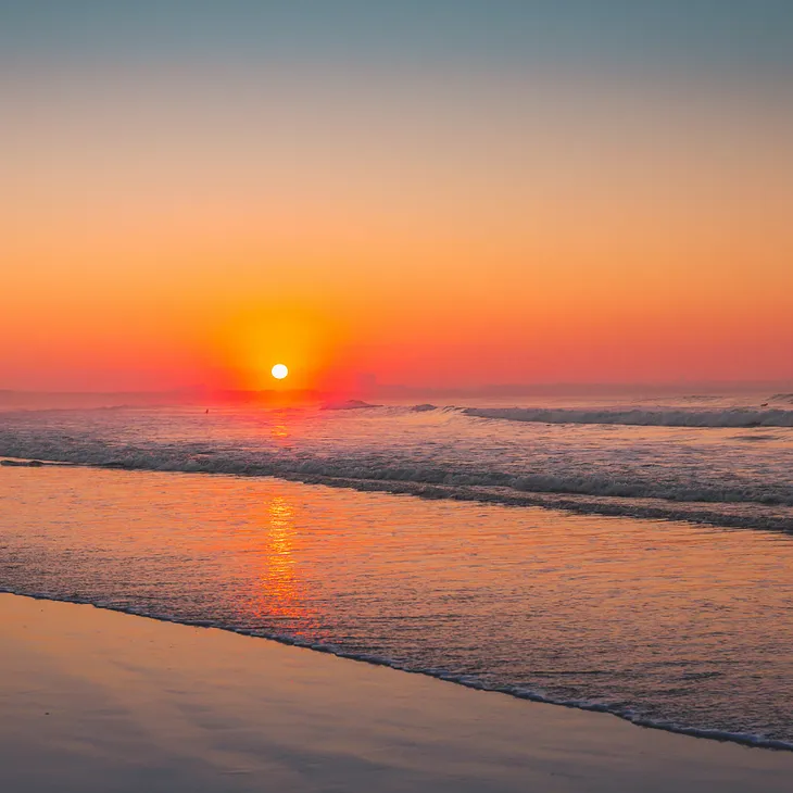 A lone figure walking along Marina Beach at sunset, symbolizing the journey of healing and new beginnings after divorce in Chennai.