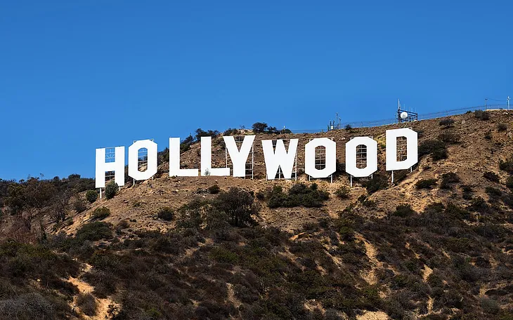 A photo of the Hollywood sign in Los Angeles, California. The letters are white and spell out Hollywood.