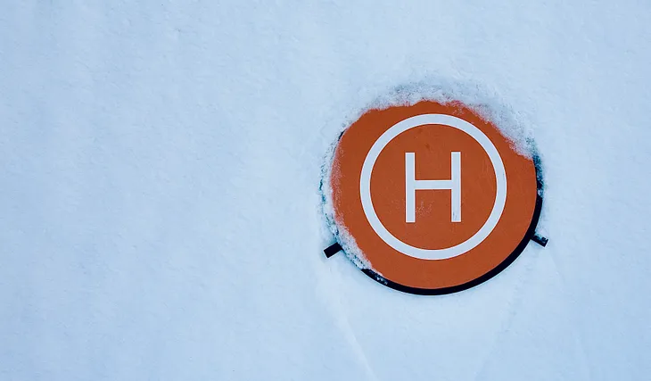 Orange coaster with an H on it in the snow