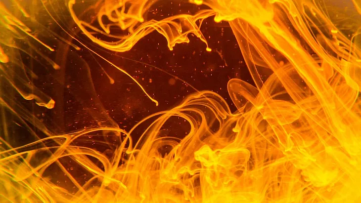 Abstract image showing orange waves which remind of flames and heat transfer