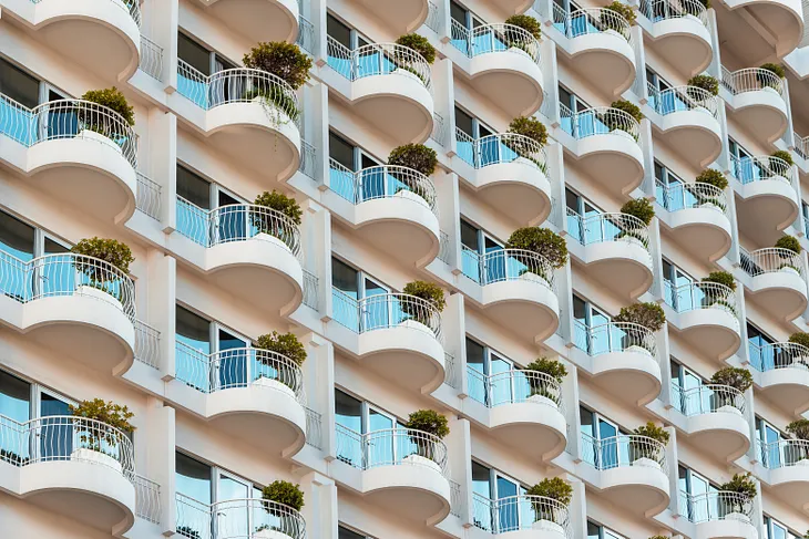 White concrete building with trees