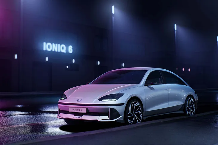 A picture of Hyundai’s Ioniq 6 on a dark street with hue lighting