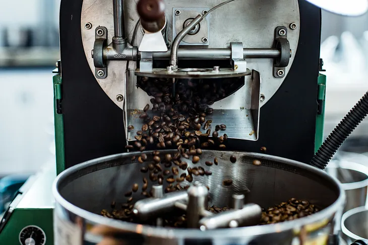 Coffee beans falling into a grinder