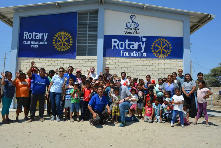 Founder Jacob Niemeier celebrates smiling with the community of Monte Castillo whose new water treatment facility in the background just became operational!