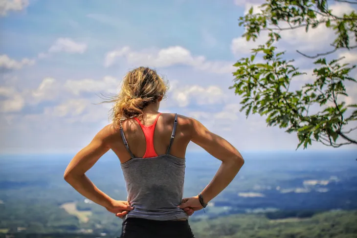 Woman runner looking out at view in contemplation