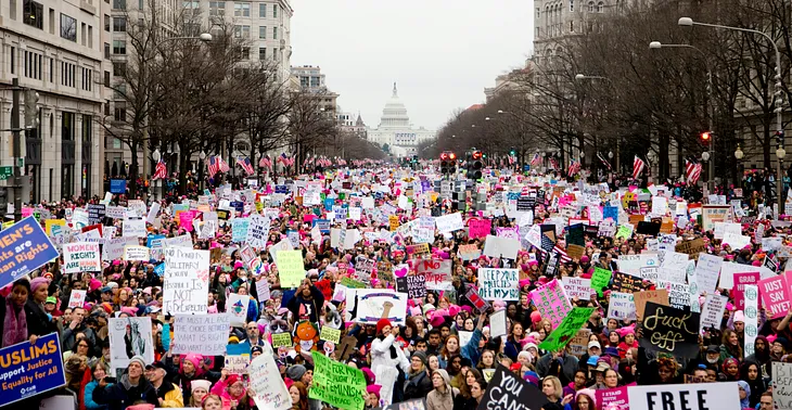 Large “pussy hat” demonstration along Pennsylvania Ave, the Capitol in the background