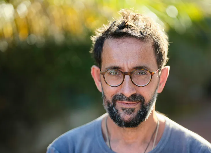 An anxious man pretends he’s okay by putting on a brave face