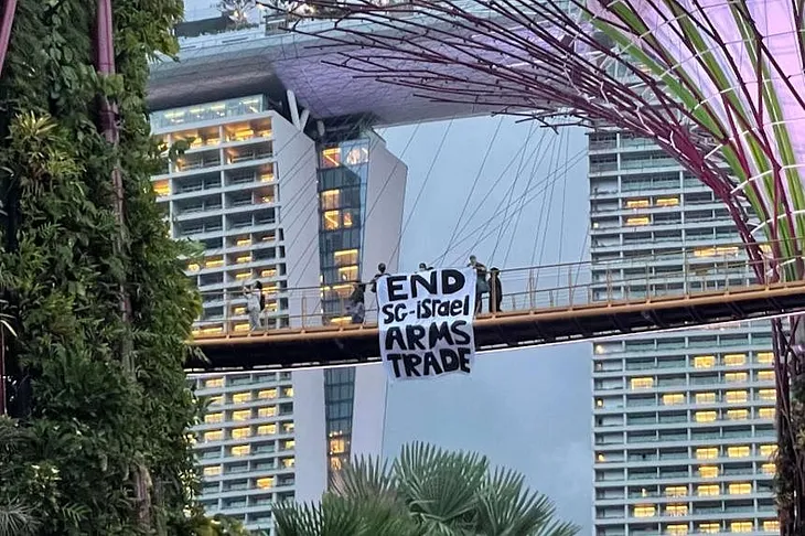 The three protesters can be seen in a video clip standing on the OCBC Skyway and unfurling a banner. PHOTO: SINGAPOREANS FOR PALESTINE/INSTAGRAM