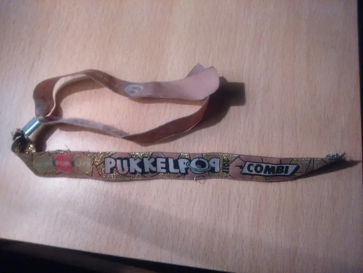 A photograph of my festival wristband from Pukkelpop 2011, sitting on a table years later