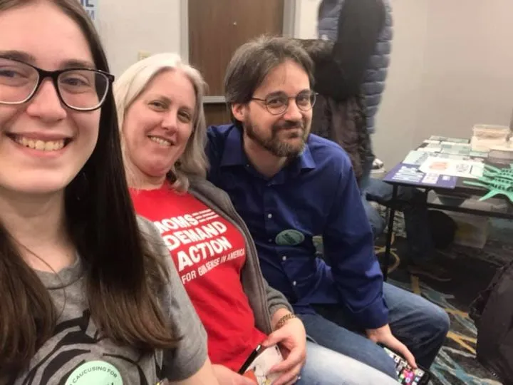 Three people at a caucus meeting in Iowa in February, 2020