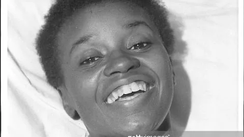 Black and white picture of a young black woman smiling