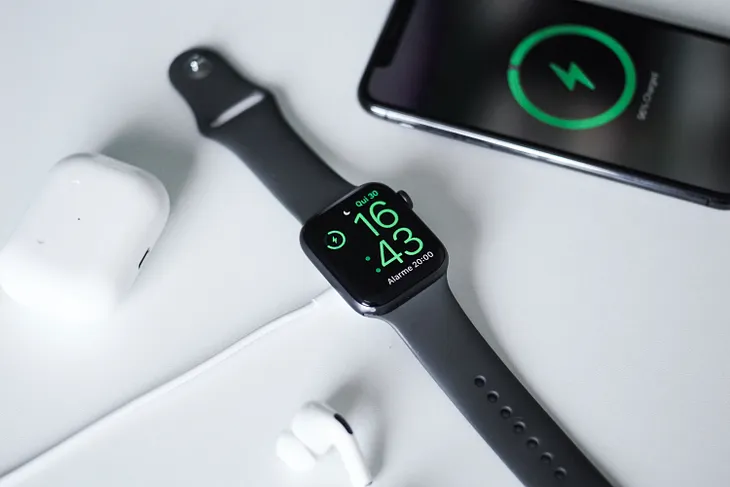 An Apple Watch, an iPhone, and some AirPods