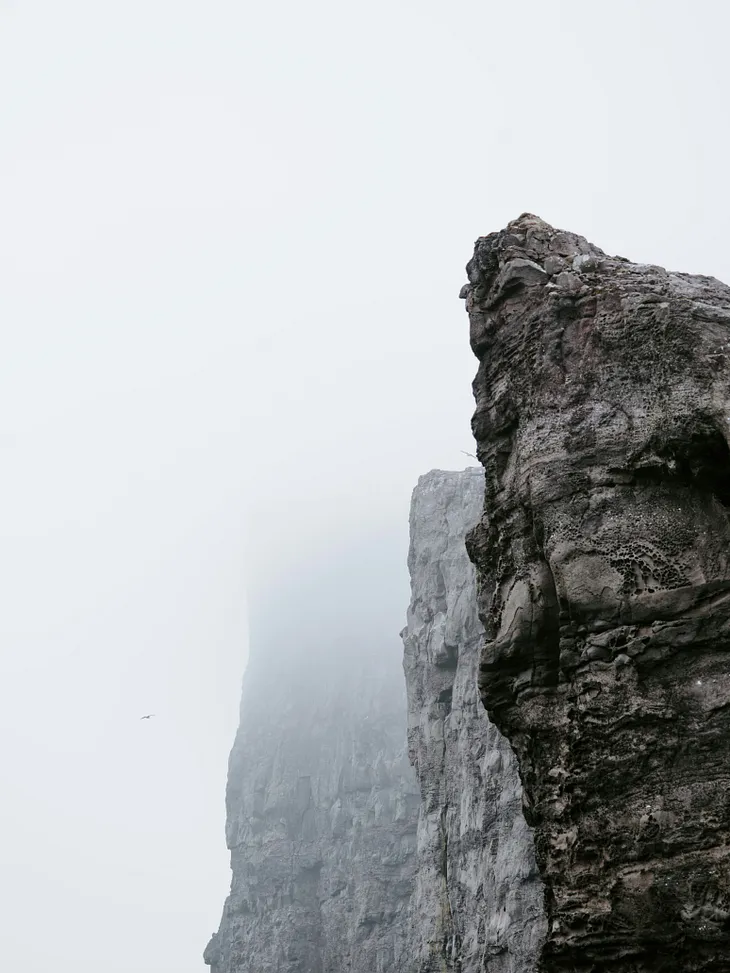 Fog surrounding a cliff face