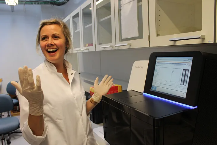 Noomi Gregersen with the sequencing machine that generated the first whole genomes from the Faroe Islands.