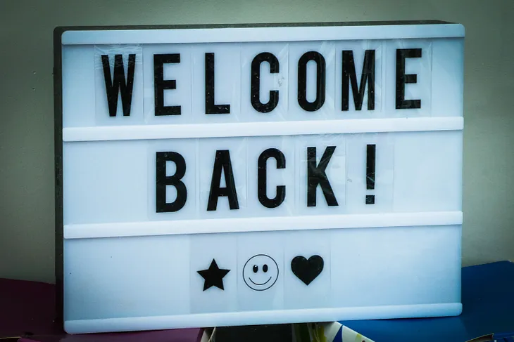 sign that says welcome back