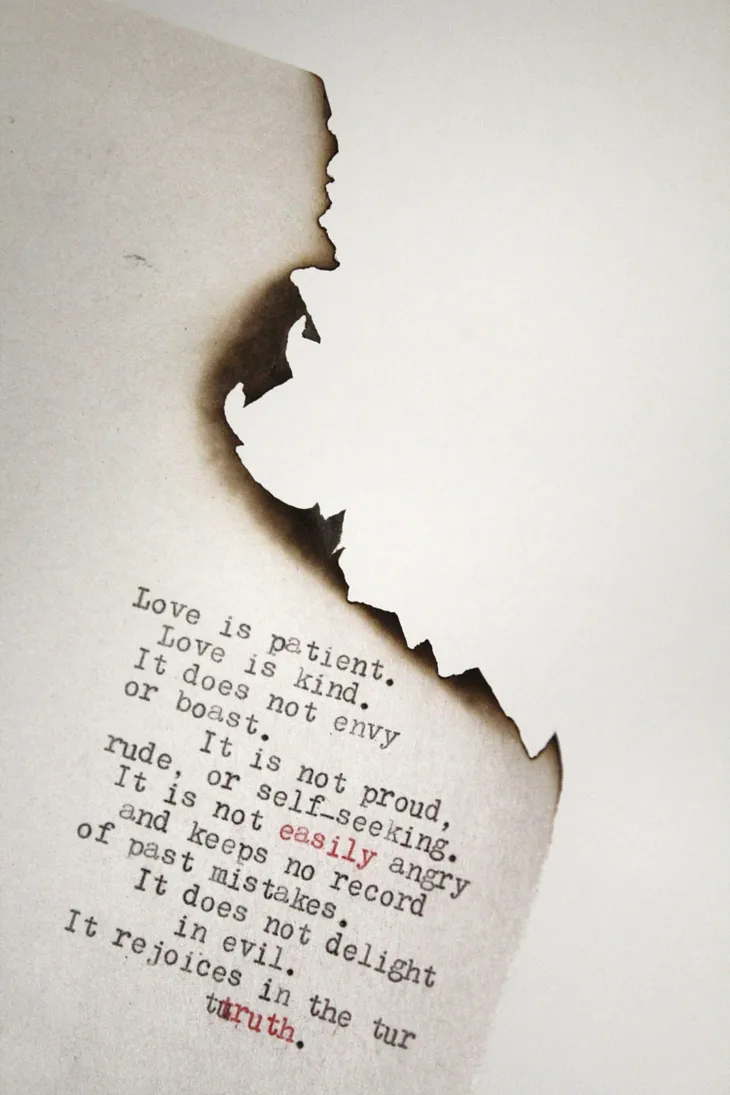 a burnt portion of a page with a poem on it